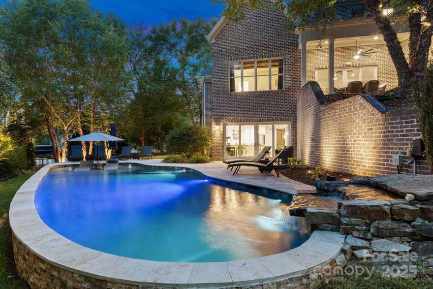 Nestled on a beautifully landscaped lot in Lewisville’s gated Montrachet, this Grand Structures custom home blends timeless elegance with inviting warmth. Tucked in a private, serene setting, the grounds feature lush landscaping and a cascading waterfall flowing into a Gunite salt water pool. Inside, this home impresses with exquisite millwork throughout. Expansive living and dining areas with generously sized kitchen - perfectly suited for both refined entertaining & relaxed family living. Oversized covered porch flows seamlessly to outdoor grill & conversation fire pit. Luxurious primary suite on main, complete with spa-like bath renovated in 2025. Refined details continue throughout versatile upstairs w/bedrooms, bonus, game room, & office extending this home of distinction. The finished basement is a showstopper - with views to pool from elegant kitchen, den and full bath. With a blend of luxury and function, this is more than a home - it's your chance to embrace the perfect life.