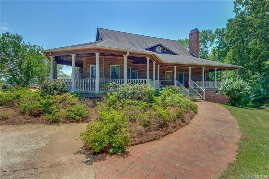Enjoy country living minutes from downtown Mooresville! Rocking chair wrap around porch welcomes guests into the large GR boasting a soapstone fp w/wood burning stove. Hickory wood floors, custom cabinets & granite counters w/plenty of work space adorn kitchen overlooking the pond/acreage w/fruit trees. Lg owner's suite on main w/sitting area & walk in closets. LL w/ full bath & 2nd kitchen. 25X25 detached shop & generator. Appreciate endless possibilities in a serene setting w/room for a barn.