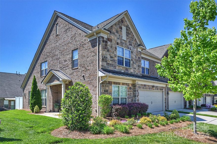 Beautiful end unit in highly sought-after Bridgemill. This home is spacious, bright and immaculate – truly like new! Two-story entry opens to kitchen, dining and living areas – wonderful open floor plan! White kitchen features SS appliances, quartz countertops and stylish tile backsplash. Living room features gas fireplace with stone surround. First floor primary suite has spacious bedroom w/vaulted ceiling, walk-in closet and luxurious bath. Great living spaces upstairs: loft, two large bedrooms plus a spacious den. Home boasts beautiful wood floors, light neutral paint, elegant moldings and 2-car garage. Upgrades include brick pavers and retractable awning over patio; sun film on rear glass doors to increase privacy while allowing wonderful natural light; custom storage system in primary closet; HEPA grade furnace filters. Excellent location across from beautiful greenspace and close to neighborhood amenities. Convenient to shopping and dining. Highly rated schools. WELCOME HOME!