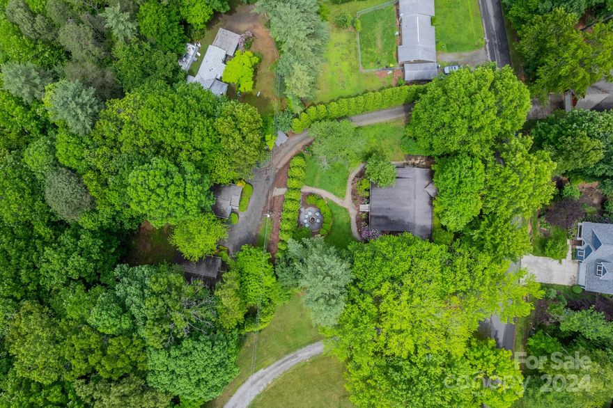 Welcome to this Short Term Rental powerhouse oasis in Asheville, NC! This property offers the best of both worlds - a charming duplex and two cozy cottages nestled on two adjoining parcels. Each unit in the duplex has a very spacious 1 bed/1 bath. Separated with a privacy curtain of mature Leyland Cyprus trees there are two 2 bed/2 bath cottages. Impeccably maintained, each residence features private enclosed decks and indulgent hot tubs. This prime location, fully furnished with rental history and future bookings, is a rare income-producing gem! Don't miss out on this rare opportunity! Outside of city limits, this property is eligible to be grandfathered in as an exemption for the new Buncombe County STR rules providing a unique opportunity to lock in a property in an extremely desirable area. It is the buyer's responsibility to confirm county zoning compliance. The property could also be utilized as a long or medium term rental. All furnishings are included and convey with the sale.