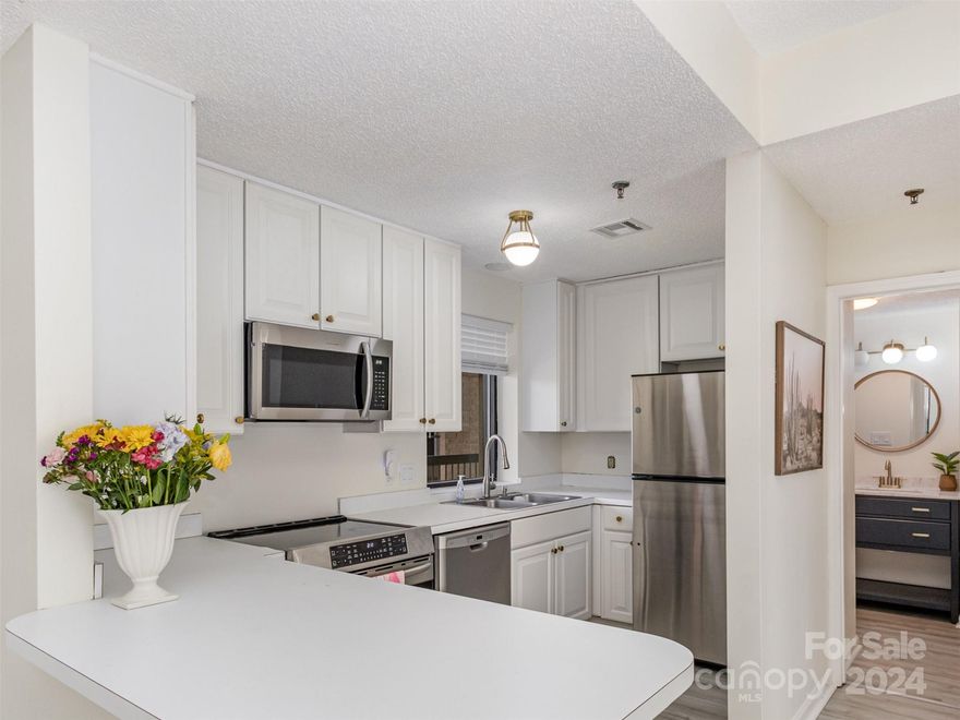 Welcome to 211 Heritage Blvd, an updated 2BR, 2BA condo in Fort Mill's Kensington Place Community! Enjoy modern living with luxury vinyl plank flooring, a white kitchen, and stainless steel appliances.  This unit's new owner will also have right to use covered parking/ storage bay no. 4.  Close to dining, entertainment, and shopping, with easy access to I-77 and I-485. HOA fees cover water, sewer, trash, and exterior maintenance for worry-free living. Don't miss out on this vibrant lifestyle opportunity!