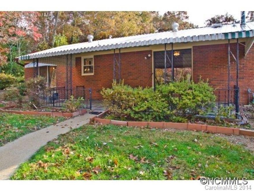 Solid brick ranch gleaming hardwood floors, relaxing covered patio in back, energy efficient replacement windows, gas furnace and central air for year round comfort, four garages, beautifully landscaped natural setting yet very convenient east location.  Enjoy being mere minutes to shopping, dining, the interstate, and the Blue Ridge Parkway.