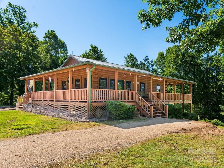 Welcome to your dreamy mountain oasis - a unique find in Saluda! As you venture down the gorgeous private drive, you come to the charming, well-maintained cabin situated on a picturesque 4 parcels totaling 18+ acres - unrestricted land that's mostly cleared, offering a variety of uses – let your imagination soar! This could be a quiet retreat as your primary or secondary home, you could easily add additional structures for a family compound, there's plenty of space for equestrian usages, there are sunny spaces that could be cultivated for gardening and food-growing – the possibilities are nearly endless!  The cabin boasts a heavenly wrap-around rocking-chair porch, downstairs has additional finished, heated studio/hang-out space that isn’t included in square footage. Solar panels keep energy costs low, the home is wired for a generator, and a large detached garage/shop has plenty of room for all of your toys and tools! Make the trip and experience this peaceful locale! Property being sold mostly furnished. The basement space is heated and finished but not contiguous so the sq footage is not included in the total.