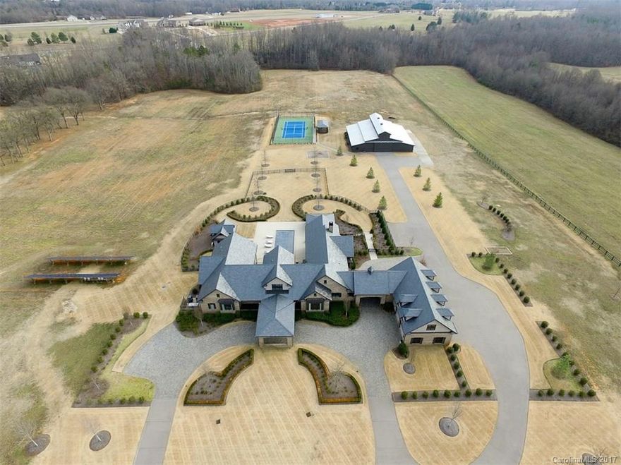 European-style, gated luxury estate on 38 acres is designed to accommodate an entrepreneur's family. Located minutes away from I-85 and I-26, this 9,400-square-foot, builder-owned brick home was constructed in 2012 from high-quality materials which features a great outdoor space complete with pool, cabana, lighted tennis court and outdoor kitchen. Features include alarm system, surveillance cameras and equipment. A large heated outbuilding offers several on-site business or horse farm options.