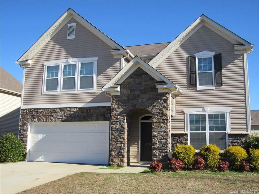 Fabulous Vinyl & Stone Two Story home offers 5 BR, 3 BA with formal DR, granite counters in kitchen, breakfast bar, open to family room with f/p.  Master suite features large master bath with garden tub, separate shower, dual vanities, plus huge walk in closet.  Fenced backyard with patio for additional entertaining.  New carpet & paint, ready for new owner!