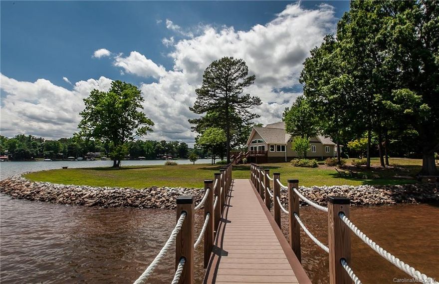 Superior lake views from this peninsula lot with breathtaking BIG water frontage that boasts 357 feet of Lake Norman shoreline. Enviable exceptional waterfront paradise with private pier, deck and porch area overlooking a flat backyard. Interior has been completely renovated with a new gourmet kitchen, stunning hardwood floors, incredible lake views from almost every room. Master and guest suites on lower level. Upper level offers large recreation area and kitchenette.