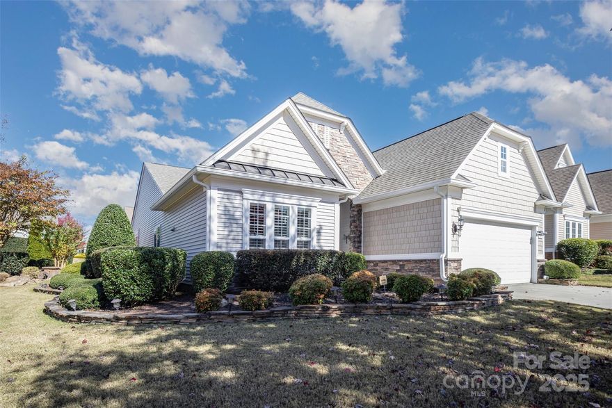 2026 - MONTHLY HOA DUES DROP TO $321. Welcome Home to 2185 Hartwell Lane and discover the perfect blend of comfort, style, and community in this beautifully maintained home nestled on a picturesque tree-lined street. Situated on a premium 0.28-acre lot, this residence offers exceptional curb appeal and a host of thoughtful upgrades designed for easy living and entertaining. The kitchen features granite countertops, abundant cabinetry with convenient pull-out drawers, updated stainless steel appliances, and a large island with prep space and a casual dining area. The open-concept design flows effortlessly into the spacious formal dining area and great room where a cozy gas fireplace creates the perfect ambiance for relaxing with family and friends. Enjoy the versatility of the glass-enclosed porch—ideal for morning coffee or reading with a view of the beautifully landscaped backyard. Step outside to custom patios that provide multiple spaces for outdoor dining, entertaining, or simply soaking up the peaceful surroundings. This home has been meticulously upgraded for convenience and peace of mind, including: Plantation shutters throughout; 2023 HVAC system and 2019 roof; Whole-house water filtration system; 4-foot extended garage and expanded driveway; Roof/attic fans, irrigation system…and much more! (See feature sheet for the complete list). Located within the award-winning Sun City Carolina Lakes community, residents enjoy resort-style amenities including golf, woodworking, canoeing,  pickleball, swimming, fitness center, tennis, pottery, softball, walking trails, and a vibrant calendar of social activities. Come experience the lifestyle you’ve been dreaming of—this exceptional home won’t last long!