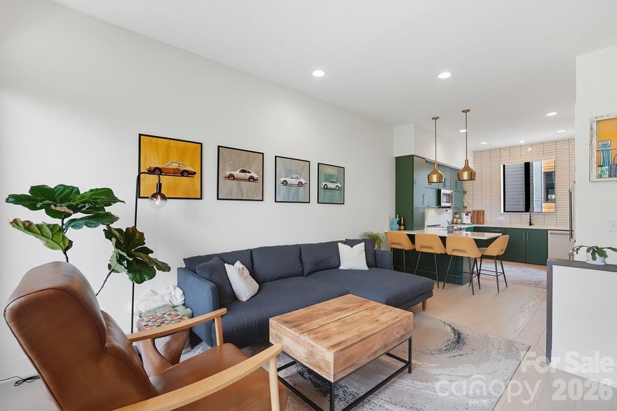 Experience the pinnacle of urban living in this 2023-built masterpiece by the award-winning Revolve Residential. Nestled in the Alloy community, this three-story townhome offers a rare blend of mid-century modern soul and high-end luxury. 

The entry level features a versatile bedroom with a full bath, providing a private sanctuary for guests or the ultimate quiet home office. 

The main level is a showstopper, featuring a designer kitchen with emerald green cabinetry, brushed gold accents, and professional-grade GE Café appliances. The living space, anchored by a custom wood-slat feature wall, transitions seamlessly through 3-panel sliding glass doors to a private, covered balcony finished in premium Thermory wood. This space is elevated by custom, automatic remote-controlled shades on the kitchen window and the 3-panel sliding glass doors.

The entire third floor is dedicated to a massive Owner’s Retreat, complete with vaulted ceilings, dual walk-in closets, and a versatile flex space perfect for a home office, nursery, or gym. Located just steps from the 36th Street Light Rail, the new Sprouts, and NoDa’s iconic dining scene, this home offers a quiet, green-view sanctuary without sacrificing city proximity.

Rounding out this tech-forward home is a spacious one-care garage equipped with a dedicated electrical vehicle charging port.