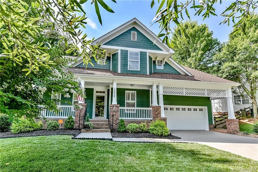 Gorgeous & designer perfect. Saussy Craftsman. 2 sty foyer & GR Rm.Frml LR & Dining. Kit w/gas cooktop, 42” cab, bar, & eat in. Luxury Mstr on Main. Sunroom overlooking treed privacy. Lg bdrms up w/ hall bath & walk ins.  Bonus/Bdrm 4 w/den. Roomy walk in attic storage. Hdwds up and down. Plantation Shutters. Fenced, stone garden back.  Irrigation.  Lot adjoins common open space.  Paved path to school across street.Shows like a model!