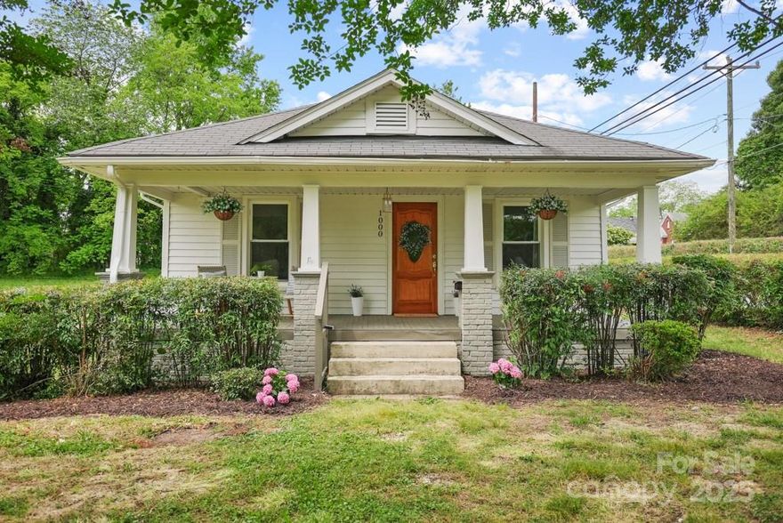 Welcome Home! Where classic charm meets modern comfort. This beautifully renovated 2-bedroom, 1-bath home has been updated from top to bottom while preserving its timeless character. Flooded with natural light, the spacious and convenient layout makes every room feel bright and inviting. Step onto the oversized rocking chair front porch—a perfect spot for morning coffee or winding down in the evening. Inside, you’ll find designer finishes throughout and an open floor plan and a comforting living space with an aesthetic fireplace. Whether you're hosting guests or enjoying a quiet night in, this home feels both cozy and contemporary. Out back, a huge yard offers endless potential. The detached 2-car garage provides ample room for parking, storage, and even a workbench for your DIY dreams. Tucked in a peaceful neighborhood, just 5 minutes from downtown, you’re close to local dining, coffee shops, boutiques, and beautiful parks. Come fall in love with 1000 Oakshade Ave!