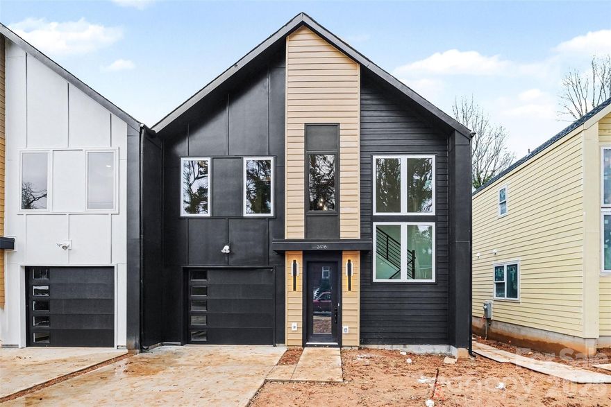 Part of the striking Crestview Duets, this brand-new home delivers modern architecture, thoughtful craftsmanship, and exceptional privacy in one of Charlotte’s fastest-evolving corridors. This 3BR/2.5BA layout offers approx. 2,300 sq ft and is anchored by a show-stopping two-story stairway with large windows pouring light throughout the home. The quartz kitchen with designer cabinetry, soft-close drawers, gold & matte-black accents, and oversized island connects beautifully to open living spaces ideal for entertaining. A dedicated office with glass doors, shiplap details, RevWood flooring, and a spa-level primary suite featuring a huge rainfall shower create a home that feels refined and substantial. Outdoors, the full-width Trex deck with privacy wall overlooks an unusually deep backyard backed by a Tree Save buffer, offering peaceful wooded views and rare seclusion for townhome living. Set in a quiet residential neighborhood with room to breathe, just steps from the Gold Line, walkable to the park, 5 minutes to Uptown, and 11 minutes to the airport. No HOA. EV-ready garage. Estimated completion mid-February.