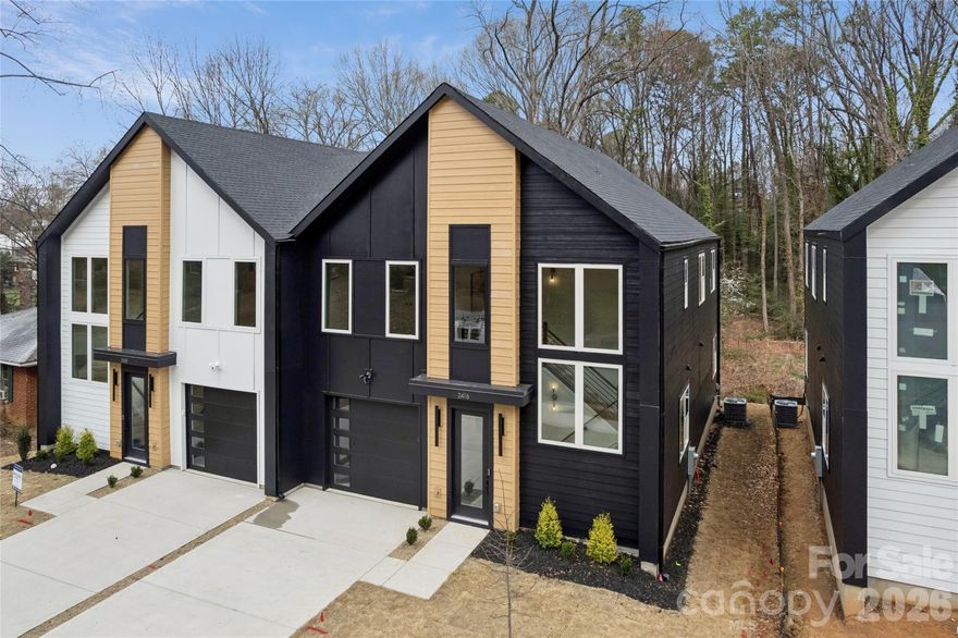 Part of the striking Crestview Duets, this brand-new move-in ready home delivers modern architecture, thoughtful craftsmanship, and exceptional privacy in one of Charlotte’s fastest-evolving corridors. This 3BR/2.5BA layout offers approx. 2,300 sq ft and is anchored by a show-stopping two-story stairway with large windows pouring light throughout the home. The quartz kitchen with designer cabinetry, soft-close drawers, gold & matte-black accents, and oversized island connects beautifully to open living spaces ideal for entertaining. A dedicated office with glass doors, shiplap details, RevWood flooring, and a spa-level primary suite featuring a huge rainfall shower create a home that feels refined and substantial. Outdoors, the full-width Trex deck with privacy wall overlooks an unusually deep backyard backed by a Tree Save buffer, offering peaceful wooded views and rare seclusion for townhome living. Set in a quiet residential neighborhood with room to breathe, just steps from the Gold Line, walkable to the park, 5 minutes to Uptown, and 11 minutes to the airport. No HOA. EV-ready garage.