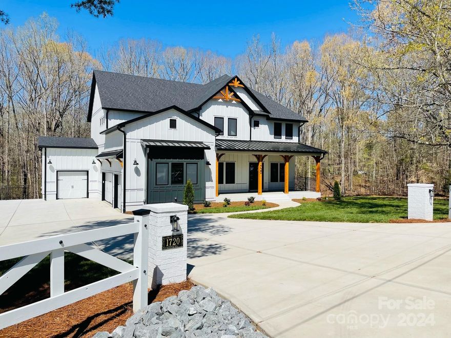 Stunning, Custom Built Modern Farmhouse Style New Construction w/ 4 Car Garage and No HOA! This open floor plan concept offers soaring 11" ceilings on the main level & exposed beams. Chef's Kit. & Scullery w/ oversized island, custom cabinetry, quartz countertops, 48" gas range, bev. cooler, vented hood & much more! Extensive cove moldings, 8" base boards, shiplap & custom accent walls throughout home. Hickory hardwood flooring. Spacious guest suite w/ separate sitting area & en-suite bathroom is a perfect in-law suite. Gorgeous linear gas fireplace & custom shelving in Great Room. Drop Zone & lockers off Gar. entry. Coffered ceilings in FDR & Office. Spacious Primary Bedroom with coffered ceiling, walk-in closet w/ custom cabinetry. Soaker tub, lg. walk-through tiled shower w/ dual shower heads & rain shower in Primary bath. The bonus room is perfect for a playroom/movie room. Screened porch w/built-in fireplace and 12x16 deck that overlooks the heavily wooded yard! Top rated schools!