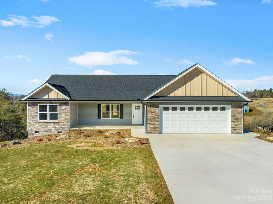 This beautiful quality-built home in the beautiful WNC mountains was recently completed and ready to be enjoyed. Sit on the covered back porch and enjoy the beautiful mountain views and the amazing sunset. The layout is an open split bedroom floor plan. This site-built home features luxury vinyl plank flooring, granite countertops, and a fireplace with gas logs. Everything is on one level for easy living. Enjoy the covered front and back porch as well as the spacious attached 2 car garage. This location is so convenient to Weaverville, Asheville, and Marshall.
