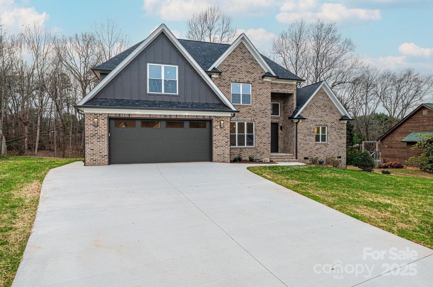 Beautiful new construction just completed in NE Hickory’s desirable North Pines Subdivision! This stunning 1.5-story all-brick home offers timeless curb appeal and a thoughtfully designed split-bedroom floorplan. The private primary suite with en-suite bath is tucked away for comfort, while a spacious guest suite with full bath sits on the opposite side of the home, perfect for visitors or multi-generational living. The heart of the home is the chef’s kitchen, featuring quartz countertops, tile backsplash, soft-close cabinetry, and premium stainless appliances including a gas cooktop, oven, microwave, dishwasher, and refrigerator. The kitchen flows seamlessly into the breakfast area and the impressive great room, highlighted by soaring two-story coffered ceilings and a modern fireplace, creating an open and inviting space ideal for entertaining. A large kitchen island with breakfast bar and a formal dining room add both function and elegance, making this home perfect for gatherings both large and small.

Upstairs you’ll find the third and fourth bedrooms, a full hall bath, and a generously sized FROG (Finished Room Over the Garage) that offers flexible space for a home office, media room, or playroom. Quality craftsmanship, designer finishes, and energy-efficient construction are evident throughout, with attention to detail that ensures both beauty and functionality. Luxury Vinyl Plank flooring, abundant natural light, and modern design touches elevate the home’s interior, while the exterior showcases classic brick construction and a welcoming presence. A two-car garage provides ample storage plus there is a tall crawlspace area perfect for a zero-turn mower and yard tools.  The spacious level yard offers space for outdoor enjoyment.

Located in the sought-after North Pines Subdivision, this home combines convenience and comfort with easy access to schools, shopping, dining, and major highways, while still providing a quiet neighborhood feel. Move-in ready and built with quality you can trust, this property is a must-see. Come and show this beautiful new home in NE Hickory—your buyers will not be disappointed!

Closets are currently do not have any shelves in them so that the buyer can determine the layout of their choice for shelving.