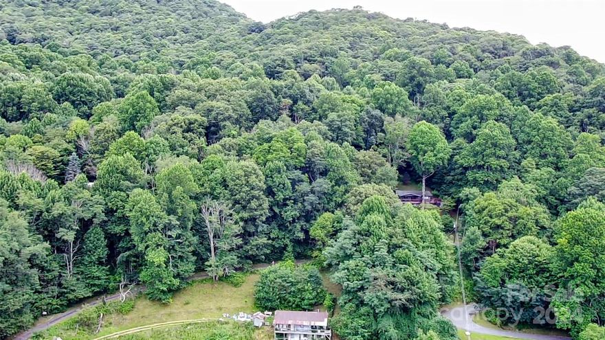 This easy-to-build, level lot offers a delightful high elevation of 3,700 feet. The paved roads provide convenient access. Purchase the adjacent lot below to clear some trees and potentially enjoy stunning mountain views, or build another house. This opportunity is definitely worth exploring.  Experience the hidden charm of this location. With a bit of tree trimming, you’ll uncover breathtaking views. Visit Friendly Acres and create your dream mountain home. Imagine yourself on your deck, soaking in this mountain subdivision's tranquility and natural beauty. Combined lots (PIN# 7695-77-8288 and 1.18 acres PIN# 7695-77-7080 for $55,000) offer even greater potential, with the seller preferring to sell them together.