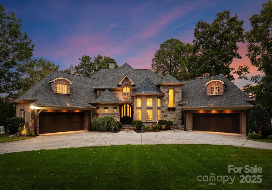 Welcome to serenity point, refined Lake Norman living at its finest—a place where every day feels like a quiet chapter in a well-lived story. Nestled on a private one-acre lot with over 300 feet of shoreline, this 6,411-square-foot estate welcomes you with panoramic main-channel views and timeless craftsmanship. Step inside to a soaring two-story stone fireplace, vaulted wood-accented ceilings in the dining room, and new hardwood floors. The main-level primary suite becomes your personal sanctuary, where mornings begin with sweeping lake views and evenings wind down beside the fireplace or in the spa-style bath.

The heart of the home features a chef’s kitchen inspiring meals and memories. Sub-Zero refrigerator, Thermador double ovens, gas range, and generous counter space—all framed by water views that invite guests to stay awhile. Upstairs, family and guests can settle into three additional bedrooms, each with sweeping lake views, or gather in the theater room, complete with classic theater seating, a drop-down projector screen, an 84" Sony 4K LED TV, and a refreshment fridge for cozy movie nights. Entertain, enjoy, or unwind in the lake-level living with a game of pool, a workout in the gym, uncorking a bottle in the wine room, or opening the doors to let the lake breeze flow through.

Experience tranquil resort-style living with your own private heated saltwater pool and spa, outdoor shower, and new 2025 patio deck overlooking the sparkling main channel. Fire up the outdoor kitchen for evening dining, then wander down to the private covered dock with boat lift, sound system, and kayak steps—ready for your Lake Norman adventures. Fenced yard, smart irrigation system, and Generac generator—every detail makes this a true dream home.