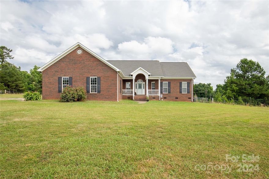 Buford home with room to play on 15 acres. All brick custom built home with open split floor plan. Screened porch overlooking the private fenced yard.