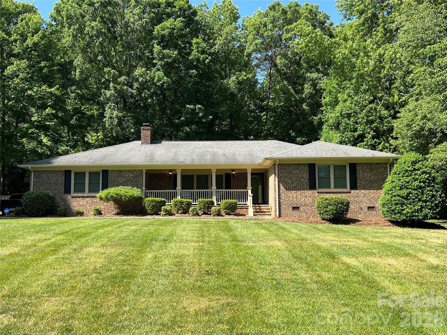 The moment you step through the door of this beautiful brick ranch home you can feel the love that this home has received!  Immaculate quality throughout!  You will love the large great room featuring a wood burn fireplace which offers a comfortable setting all year through.  Just off the great room is the updated and inviting kitchen with Quartz counter tops, tile backsplash, tile floor, electric range, microwave, dishwasher, eat on bar/island, and a convenient pantry.  Enjoy entertaining?  This home features a spacious dining room just off the kitchen and great room with doors leading to the deck that makes entertaining a breeze.  Just in time for those summer cook outs! A great highlight of this home is the extra room just off the laundry room.  It could be a home office, craft room, or great storage for your holiday decor.  The two secondary bedrooms are spacious and situated around the updated full bath boasting tile flooring and a beautiful tile shower.  Finally you've made it to the primary suite!  What a wonderful retreat after a long day at the office, or caring for the family.  This bedroom has plenty of room for a reading or sitting area, a walk in closet and secondary closet for ample storage.  The en suite bath is just beautiful and has a oversize soaking tub that is sure to melt away the stresses of the day. Early morning person?  You will certainly enjoy your cup of morning coffee on the relaxing front porch with stone flooring and hooks just waiting for your porch swing.  A two car side load garage, large beautiful lot, wonderful community, and convenient to both Mount Holly and Stanley.  This elegant home is truly one you don't want to miss!