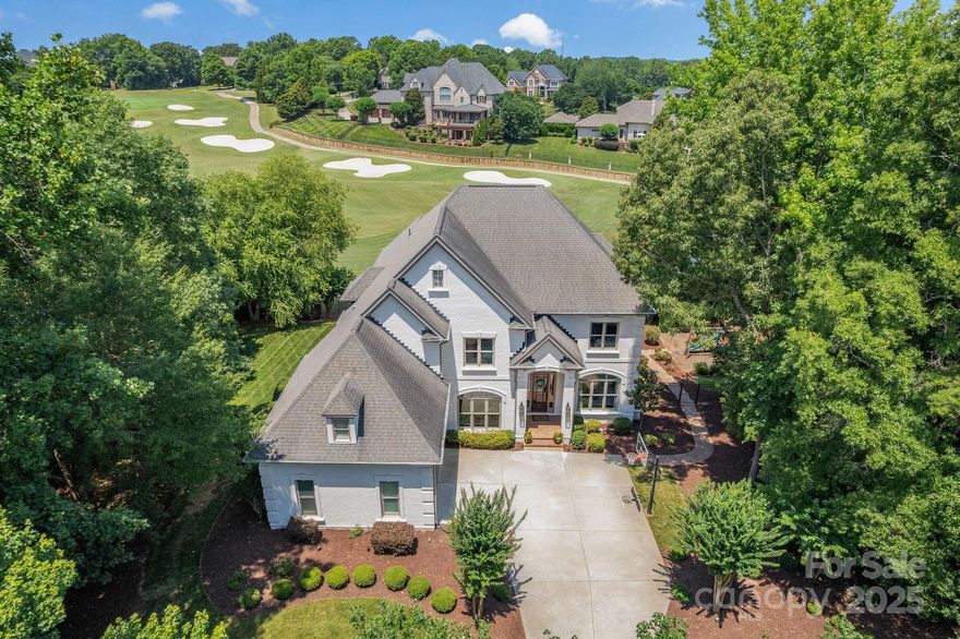 Welcome to your private paradise in Marvin! This stunning, fully renovated home (June 2025) offers luxury and long-range views of the 6th hole at the Country Club of the Carolinas. Step into a light-filled foyer leading to open living areas with soaring ceilings, hardwood floors, and a gourmet kitchen with a large island, bar seating, and eat-in space. Enjoy sunsets from the main-level balcony, plus a formal dining room, sitting area, office, and family room with built-ins and gas fireplace. Upstairs you'll find the primary suite, three additional bedrooms, three renovated baths, and a spacious bonus room. The finished walk-out basement features a guest en suite, gym, bar, game area, and large sitting space. Step outside to a covered patio with remote blinds, overlooking a saltwater pool, lush backyard, and the golf course. This exceptional home combines luxury, views, and top-rated Marvin Creek schools for a truly unique lifestyle.