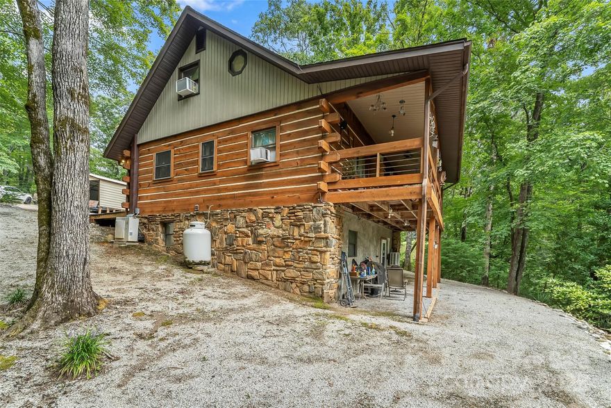 Just a hop and a skip from beautiful Lake James, this unique 10-acre retreat offers unmatched privacy and direct access to nature. Bordering 38± acres of NC Wildlife Game Lands that connect to the North Fork of the Catawba River, it’s a dream come true for hunters, preppers’s, and anyone who craves an off-the-grid lifestyle while only minutes from downtown Marion. The charming log cabin is tucked deep into the woods and accompanied by multiple outbuildings for storage, workshop space, or self-sufficiency projects. A tranquil stream meanders through the property, adding to the peaceful, secluded feel. Whether you’re seeking a hunting camp, a survivalist’s haven, or a quiet escape from the world, this property delivers the rare combination of natural beauty, privacy, and proximity to Lake James.