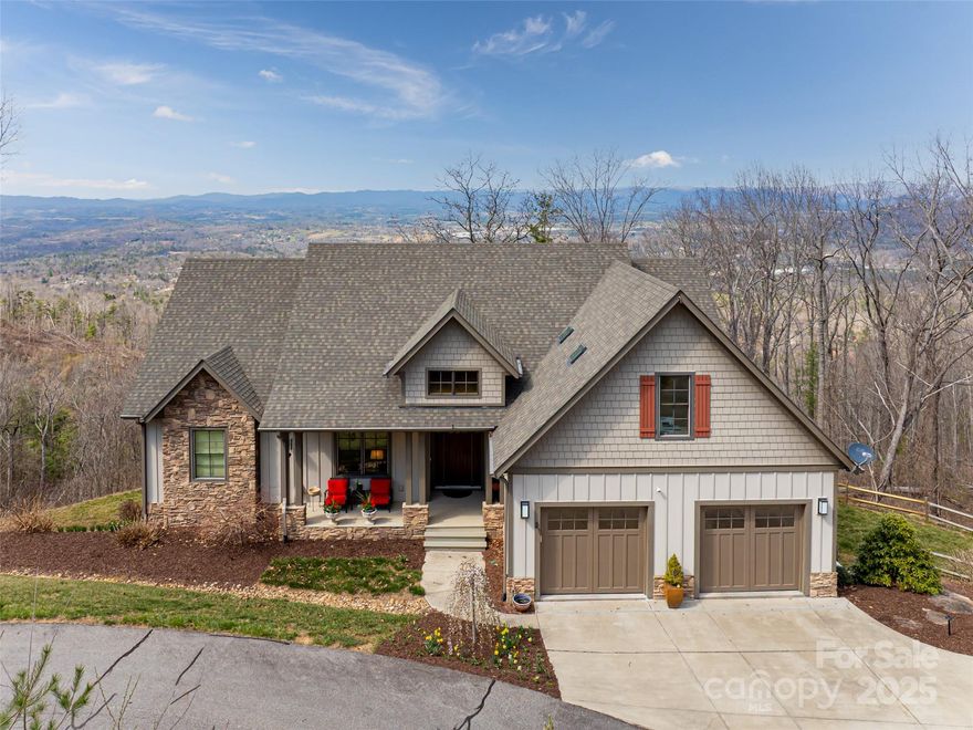 Perched in the heart of the mountains, this custom-built Red Tree Builders home offers quality craftsmanship and modern mountain charm. Designed for both connection and solitude, it features an open-concept layout with breathtaking northwest-facing views—layer upon layer of stunning mountain ranges. The kitchen, a true gathering space, boasts an oversized island, high-end appliances, and luxury finishes. Step onto the screened porch to dine or unwind by the outdoor gas fireplace, soaking in the beauty that surrounds you. The primary suite and two lower-level guest rooms offer endless views, while the spacious family room provides the perfect setting for movies and game nights. Ample storage flanks the lower level, with a hidden gem beneath the oversized garage—ideal for a workshop, wine cellar, or creative space. A bonus room above the garage offers even more flexibility. With a tankless water heater, natural gas, and city water, all within a gated community.