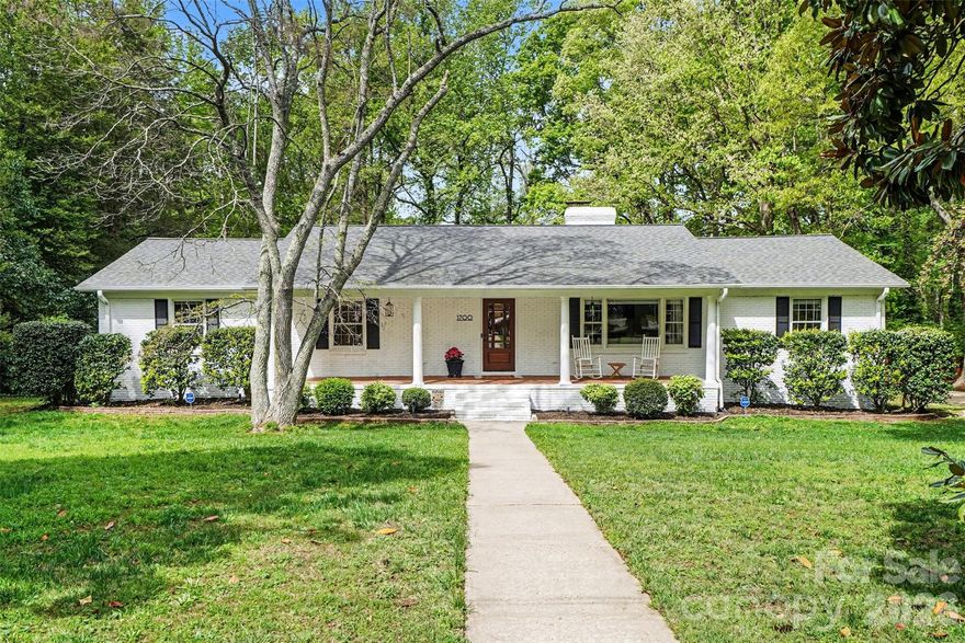 Beautifully updated full-brick home on nearly 1.4 acres in Charlotte! This 1960s-built home has been thoughtfully maintained and enhanced, blending original character with high-quality modern updates throughout. Offering close to 3,200 finished square feet with an additional nearly 1,200 unfinished square feet. This 4-bedroom, 2.5-bath home provides both space and style in a rare, private setting.

From the moment you arrive, you’ll notice the refreshed exterior with freshly painted white brick, rocking chair front porch, stately pillars and mature trees, creating standout curb appeal. Inside, the home features fresh interior paint, upgraded lighting, and hardwood floors throughout the main level. The fully renovated kitchen is a highlight, showcasing brand-new cabinetry, quartz countertops, and a modern backsplash.

The main living area includes two fireplaces, while the spacious sunroom offers additional living space filled with natural light and views of the backyard. There are four generously sized bedrooms and updated bathrooms, providing flexibility for family, guests, or a home office.

The finished portion of the lower level is designed for recreation, currently featuring a billiards room and a dedicated workout space. Beyond that lies an incredible 1,200 additional square feet of unfinished area—a blank canvas perfect for a high-end workshop, massive storage, or future expansion.

Step outside to a large elevated concrete patio or down into the lower brick patio in your private park-like backyard—ideal for entertaining or creating your own outdoor retreat. With 1.39 acres, there is plenty of room to spread out while still enjoying convenient access to the Whitewater Center, Charlotte Douglas Airport, and major highways including I-485 and I-85.

A rare combination of character, space, and beautifully executed updates—this home truly stands out.
