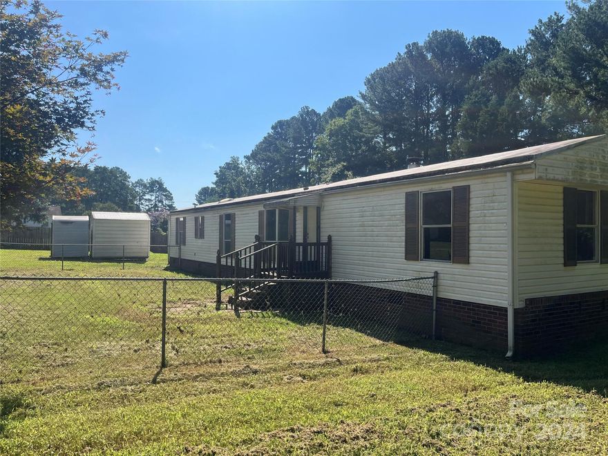 Private .75 acre lot, open floorplan singlewide with 2 bedroom, 2 bathroom.  Fenced yard, 2 car carport, 2 storage sheds.  NEEDS WORK and priced accordingly.