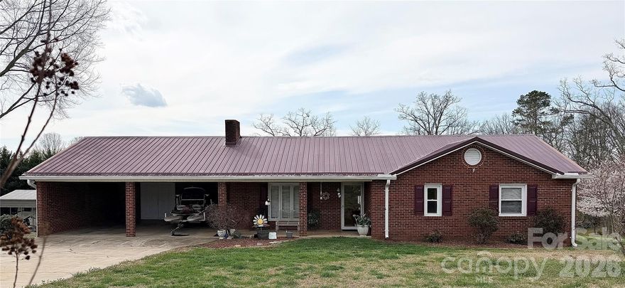 Move In Ready, Mostly Brick, One Level Home in Desirable Shady Oaks Subdivision! 2 Car Attached Carport with Storage, Metal Roof, and Replacement Windows! Large Yard with Flowering Trees and Perennials! Nice Outdoor Building! A Charming Front Porch leads to a Large Open Floor Plan with Cathedral Ceilings, Beautiful Hardwood Floors, and Gas Rock Fireplace! The Living Room Flows to the Dining Room, which is open to the Kitchen. A Spacious Laundry Room is just off the Kitchen and Carport. A Bright Sun Room, Perfect for All Seasons, is just off the Dining Room! There is a Large Hall Bathroom, and both Bedrooms are Spacious with Vinyl Plank Flooring! The Primary Bedroom has an attached Full Bathroom. This House Needs a Buyer to Make it a Home! Call Today, and I'll Arrange A Date to Give YOU The KEYS!