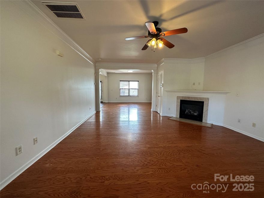 This fantastic 4 bed, 2.5 bath, 2,350 sq. ft. home in the Greencroft community of Mooresville, NC is just waiting for you! Your spacious living room welcomes you with crown molding, beautiful wood laminate flooring and a cozy fireplace. The open plan family room and eat-in kitchen offer even more space to relax and entertain. The gorgeous, eat-in kitchen is adorned with a tile backsplash, stainless steel appliances and tons of counter and cabinet space. A single French door opens to the backyard patio, a perfect spot for outdoor dining!  
Upstairs, your primary bedroom boasts a walk-in closet and an en suite bath with a dual-sink vanity, garden tub and separate shower. A bonus loft area and three additional bedrooms share a second full bath.