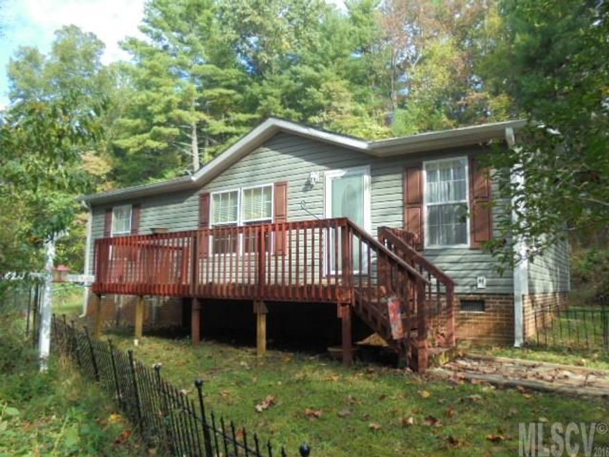 UPDATED BETTER THAN NEW 3 bedroom 2 bath modular home in the Gamewell area of Lenoir NC. Vaulted ceilings in the living room really open up the main family area. The large eat-in kitchen is fully equipped with with all appliances included. Master suite has a private full bath w new walk-in shower and vanity with glass vessel sink. There are 2 addt bedrooms and a 2nd full bathroom. The laundry room, with stackable washer and dryer that stays, leads to the rear deck and fenced back yard. Interior has new laminate flooring in living areas and bedrooms. Located in a well established neighborhood yet very private due to the heavily wooded lot. Home is move-in ready and comes with a 1 year home warranty for the new owner's peace of mind and outbuilding for all your storage needs. Sale includes 2 adj lots for a total of 1.39 acres