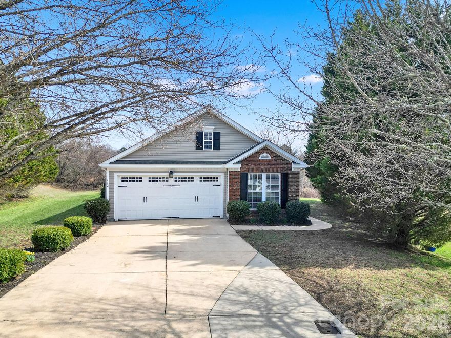 Beautifully maintained one-level home, tucked away on a quiet cul-de-sac lot, in charming Mount Holly. From the moment you step inside, you’ll appreciate the abundance of natural light, neutral paint, and LVP flooring throughout the main living areas. Kitchen features stainless steel appliances, granite countertops, stylish backsplash, and breakfast bar with seating. The kitchen flows seamlessly into the family room, where a cozy fireplace and custom built-ins provide the perfect setting for both everyday living and entertaining. The bedrooms offer vaulted ceilings, while the primary suite serves as a relaxing retreat with its attached bathroom and generous walk-in closet. Step outside to enjoy a fenced backyard complete with a patio and deck. Two-car garage provides added convenience and storage. Enjoy the neighborhood playground. Located in the heart of Mount Holly, known for its historic downtown and welcoming small-town feel, this home is just minutes from the Catawba River, River Hawk Greenway, and Tuckaseegee Park, and the U.S. National Whitewater Center. Easy access to Uptown Charlotte.