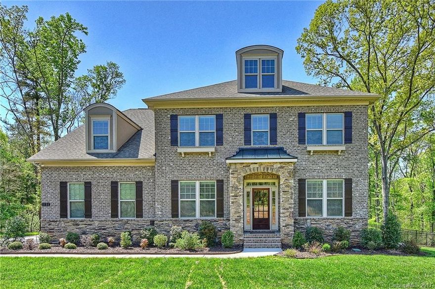 Stunning luxury brick home on 1 acre located in gated community, minutes from Ballantyne! Backyard oasis includes gunite pool & year-round custom enclosed patio w/stacked stone fireplace & wood beamed vaulted ceilings! Well equipped Chef's kitchen w/ large center island, gas cooktop. Spacious bedrooms/granite in all baths. 10 ft. Coffered ceilings, extensive trim work & beautiful hardwoods are just a few of many high end features. Tranquil, fenced yard surrounded by trees. Low Taxes! Don't Miss!