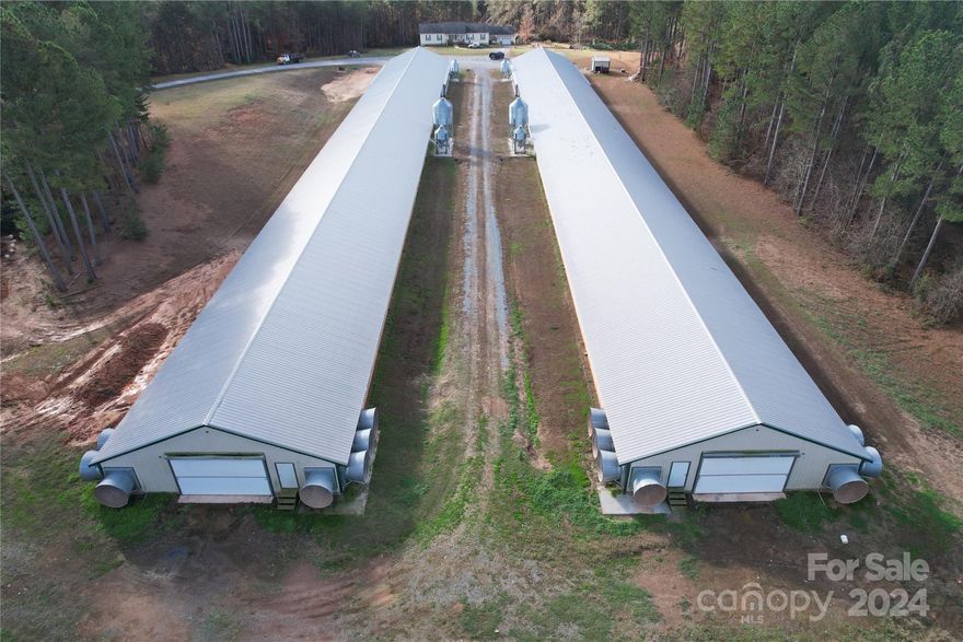 This well-established poultry farm is located on 20+- acres in Union Mills, just 10 miles from Forest City. This income producing  property features 2 fully operational layer houses, each 42’ by 500’, providing +/-6,000 eggs/day per the seller. Both poultry houses were built in 2014 and have undergone upgrades as confirmed by the seller and subject to verification with the integrator. There are 2 wells on the property, along with a Cummins generator to ensure a reliable power supply. A side-by-side utility vehicle will also be included in the sale. The home on the property is a two-story residence with a detached 3 bay garage. The upstairs features four bedrooms and two bathrooms, while the downstairs includes two bedrooms and one bathroom, offering ample space for comfortable living. This property is ideal for those looking to expand their agricultural operations or enter the poultry industry, with a well-maintained infrastructure and a convenient rural location close to nearby towns.