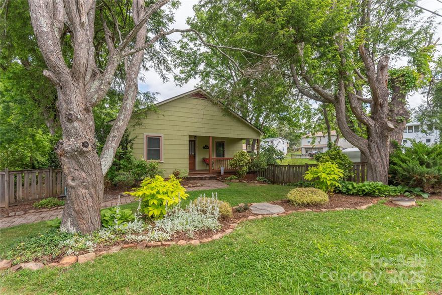 Step into timeless charm with this beautifully preserved 1940's home where vintage character meets modern comfort. The welcoming front porch brings you into a cozy and efficient floor plan. Original hardwood floors, high ceilings with expansive bright kitchen with access to outside screened in seating area. Interior Steps takes you downstairs  to a family room, a nice size bonus room with windows, wet bar and laundry area and a screened in outdoor dining area or space to play board games or cards. Fenced in yard with firepit as well as grassy play area for all. Experience the perfect blend of small-town charm and modern convenience with access to a leisurely stroll to local cafes, boutique shops and community events that define the Main Street lifestyle.  Everything you need is just around the corner.  Successful STR history. So many options, you can use this as your primary home, or a quiet and peaceful 2nd home away from home or an income producing property. Book an appt. Today!