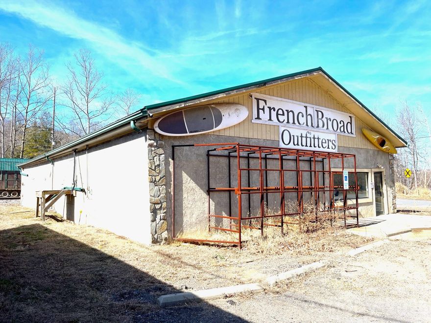 This once vibrant outfitters was flooded during Helene and now offers great potential for a new owner. Located next to the French Broad River in North Asheville at Pearson Bridge, this site offers easy river access just upstream from Riverside Park and the new Taylor's Wave, a permeant whitewater wave attraction. The Riverlink Gateway Park project also runs along Riverside Drive in North Asheville which will link this area to The River Arts District increasing visitor flow. 
Building was completely flooded in Helene with water levels peaking at nearly roofline. It has had drywall and all other materials removed and is now a shell with partitions including 1 bathroom.
Also includes a shed/boathouse. 
Being sold "As-Is" and seller can make no representations.
Subject to court approval and a 10 day upset bid period.