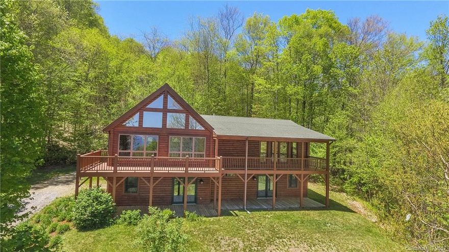 Gorgeous 3BD/3BA Private Log home in desirable Villages of Plott Creek. Home boasts beautiful granite top kitchen, open floor plan, cathedral ceiling GR w/ beautiful long range mountain views, huge porch for entertainment, and 2 spacious Masters on the main level. Basement offers Additional BD/BA, huge family/rec room, office, huge covered porch, and 1-car garage. Enjoy serene privacy in this home situated on wonderful 4.9 acre lot