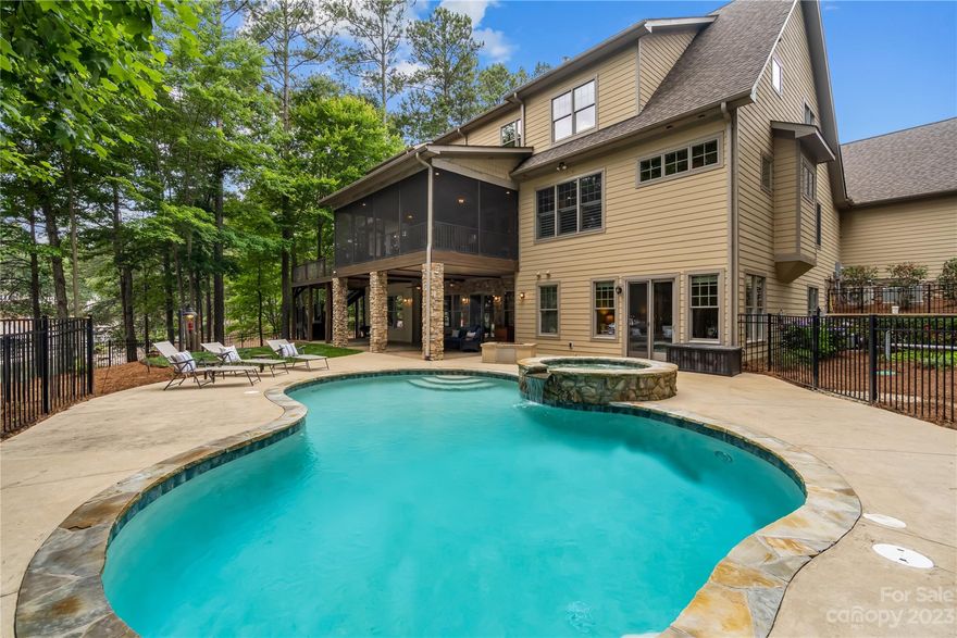 Boasting 400' of Lake Norman shoreline, this 2016 custom home sits on a point lot featuring a sandy beach, covered boat dock w/16,000 lb lift & dual jet ski ports. This sprawling home was built to accomodate the masses & is an entertainer's delight! Featuring dual 2-car garages, 2 kitchens, 3 laundries, an elevator, huge screened porch, wrap around deck, pool, hot tub, indoor sauna & theatre room, there is space & fun for everyone! Main-level features an amazing kitchen w/ large island/eating bar; dual sinks, ovens & dishwashers all overlooking large sitting room, gas log fireplace & a wall of windows. Great room features coffered ceiling, bar area w/icemaker & beverage fridge, built-ins & gas fireplace. Primary bedrooms on main & upper levels, with no details spared including large walk-in closets, walk-in shower & oversized whirpool tub. LL walk-out could be full secondary living quarters feeding out to pool. Stand-by generator. Too many features to list - just WOW!