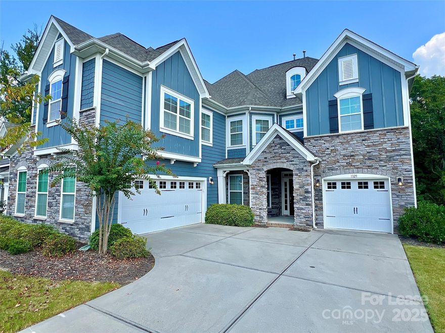 RARE! 5 Beds with ALL THE FEATURES! From the curb appeal, to the 2 story bookcase, to the 2 primary suites, you'll be amazed at every turn. As you enter the front door your focus will immediately move to the grand living room anchored by the one of a kind 2 story bookcase with rolling ladder. Make your way to the kitchen and find not 1, but 2 kitchen islands, wall oven, gas stove, huge walk-in pantry, butler pantry, and computer nook. The main floor also includes the laundry room, formal dining room, and a guest suite with full bath. Upstairs the surprises continue; enormous and well-equipped primary closet; 2nd primary suite with walk-in closet and private bath. Two additional large bedrooms, another full bath, and a bonus room round out the upstairs. We haven't mentioned the convenient location close to shopping, dining, I-85, and great schools. The two separate garages! Use one for storage and the other to park your vehicles. The two car garage even includes an EV charging outlet!