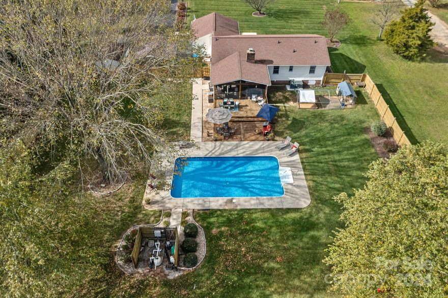 NO HOA! Beautifully Updated move-in ready Ranch has over 1-Acre of pristine level yard with AMAZING Screen Porch, POOL and plenty of space for entertaining! The Fully Fenced Backyard includes a sparkling in-ground pool w/ new liner 2023, Screen Porch, expansive 2-tier deck and chicken coop. The impressive interior has wood-burning brick fireplace that is a focal point of the spacious open floor plan. Long list of Updates: NEW HVAC 2024, RINAI tankless Hot Water Heater, Kitchen and appliances (2023/2024), Tile Backsplash, Super Cute Lighting, Ceiling Fans, NEW LVP flooring 2022 and Paint 2021. Bathrooms have NEW vanities, mirrors and tile floors. Even the 2-car attached garage has been improved to a workshop with 200-Amp/3-phase Power and AC-split system to stay cool while working! There is a shed and carport for additional parking & storage. Ideal location in popular Cabarrus County school district. The home is 4-Beds with a 3-Bed septic permit.