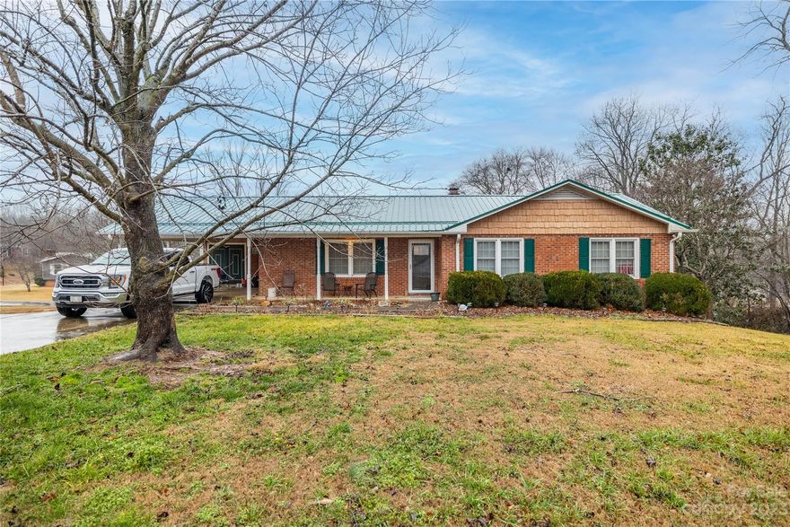 Great value in this 3 bed/2 bath brick ranch style home with full basement! From the attached carport you enter the laundry room with closet and cabinetry. Then enter the open concept eat-in kitchen with SS appliances, granite tops, breakfast bar, tile backsplash and fireplace in dining area! Off the dining area you will love the huge covered back deck! There is a spacious living room and two remodeled full baths also on the main. The primary bedroom offers a private bath with granite topped vanity and custom tiled shower with rain head. Get space in the unfinished garage... 1 garage door, a storage area and open area currently used as a family room. The basement does offer a propane wall heater. IMPROVMENTS....metal roof 2020, HVAC 2022, DECK 2020, remodeled bathrooms 2020-2021. Outside you will enjoy the storage building, extra metal carport and most of the a great view of the large pond!