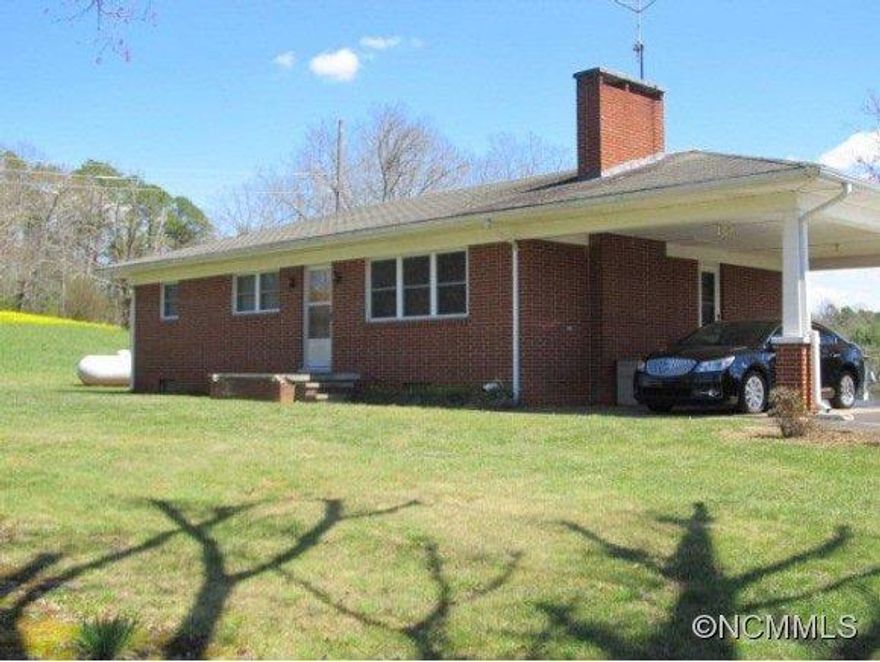 Great property, minutes from Brevard,Asheville, and Hendersonville.  Would make great property for horses, agriculture property, another house site possibility.  Taxes based on an agriculture rate.  Field is presently leased.  Hardwood floors, propane heat, central air, security system.   Full unfinished basement.  One car garage in basement. Acreage is pulled from Deed (see attachment)Boylston Creek on back of property.