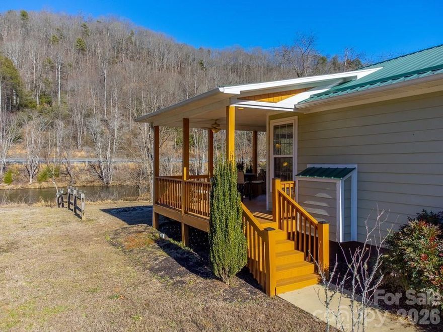 Turn-key RIVERFRONT home with mountain views in Tuckasegee River Landing. This 2-bedroom, 2-bath cottage offers direct access to the Tuckasegee River and is ideal as a full-time residence, vacation home, or short-term rental. Interior features include 9-foot ceilings, granite countertops, and a brand new HVAC system. The open living area flows to a spacious covered porch and deck, with direct deck access from the primary bedroom. Outdoor spaces provide ample room for relaxing or entertaining while enjoying river and mountain views. Water did not reach the home during Hurricane Helene. The Great Smoky Mountains Railroad passes daily in the afternoon as part of its tourism route to Dillsboro if scheduled. Perfectly situated and less than 20 minutes to Dillsboro, downtown Sylva, Bryson City and Harrah's Cherokee Casino Resort. All you need is your toothbrush!