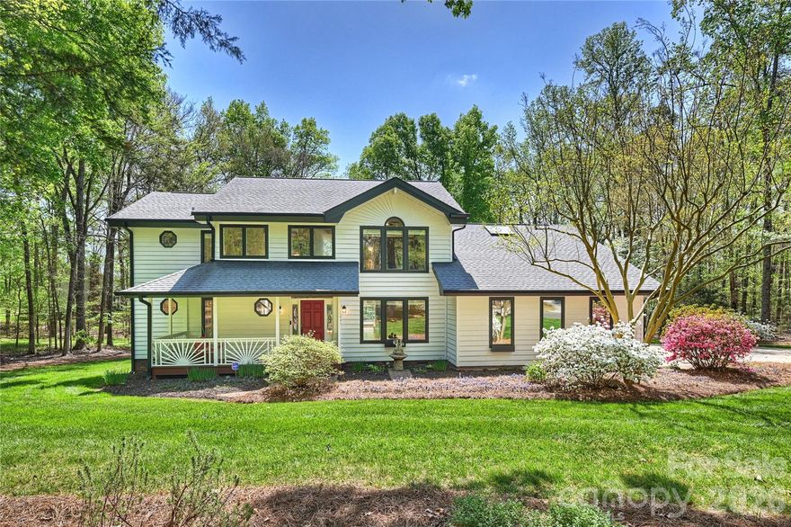 Come home to this traditional two story, three bedroom, three bath, 2,635 square foot residence featuring Craftsman inspired details, classic gables, and a welcoming front porch. Set on a beautifully wooded 2 acre lot in the aptly named Tranquillity neighborhood of Kannapolis, the property offers a peaceful natural backdrop enhanced by thoughtful landscaping and seasonal flowering plants. Inside, a dramatic foyer opens to a stunning vaulted living room with exposed beams, expansive windows overlooking the wooded backyard, and a brick fireplace that anchors the space. Natural light pours in throughout the day, and the room’s open flow connects seamlessly to the deck and adjacent living areas. French doors lead to the bright, refined formal dining room, which transitions gracefully into the kitchen and breakfast area. The thoughtfully designed floorplan includes a private main level bedroom ideal for guests or a home office. Upstairs, two additional bedrooms, including a spacious primary suite, are arranged in a desirable split layout for added privacy, accompanied by a generous bonus room with laundry. Outdoor living shines with a large deck and hot tub overlooking the trees, along with a charming screened patio perfect for quiet mornings or relaxed evening gatherings. Practical upgrades include an encapsulated crawl space, a spacious three car garage, and a tankless water heater. Climate control is efficiently managed with gas heating for the main level and upstairs guest bedroom, complemented by a new electric heat pump serving the primary suite and bonus room. The home’s location offers a balanced blend of tranquility and convenience, with quick access to I-85 for commuting and nearby shopping, dining, and services along the Kannapolis Highway corridor. The neighborhood provides a quiet, residential feel while keeping you connected to the essentials of modern life.