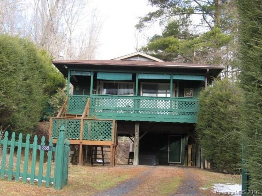 Mountain View is yours from 2BR/1BA cabin on 1.42 ac located West of town close to Asheville & only 5 mi. from Burnsville.  Beautiful drive along Cane River on way to home. Open LR & DR, kitchen, utility rm. Covered deck on front to enjoy mtn view. Land nicely landscaped, wooded & sloping w/old barn at end of parcel. Could have a garden area. Walkway from Cane Mountain Lane to covered porch. Carport Under home + storage area could be finished into additional living space.