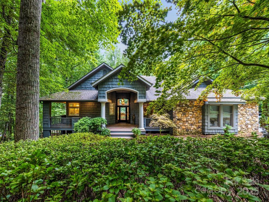 Nestled in Champion Hills above the 12th green, this artists mountain retreat home pairs modern luxury with an eclectic, world-travel flair. Thoughtful updates and attention to detail bring comfort and style together. From the Samsung Frame TV on a hydraulic TV lift that preserves the aesthetic of the fireplace wall, Brazilian Quartzite countertops in the chef's eat in kitchen to all the wood floors. The main level’s soaring great room and primary suite offer ease of one-level living, while the terrace level is designed for both fun and function with a family room, office, guest suites, and a wet bar. Multiple porches and decks encourage life outdoors - morning coffee on the screened porch, evening wine on the open deck, or quiet afternoons on the covered terrace. Plush yet practical, with golf cart storage, workshop, and abundant space, this home invites you to live serenely in the Blue Ridge Mountains while
only minutes from downtown Hendersonville.