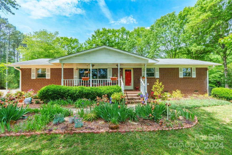 Step into comfort and charm with this delightful 3 bedroom, 2 bathroom brick ranch home. A covered front porch welcomes you, offering a glimpse of the inviting curb appeal. Inside, laminate wood floors create a warm ambiance throughout the home. The adorable kitchen is a focal point, boasting a breakfast bar, center island, stylish backsplash, stainless steel appliances, and a window over the sink with views of the yard. Retreat to the primary bedroom with its ensuite bathroom featuring a dual vanity. Enjoy ample relaxation space in the large sunroom, perfect for unwinding or entertaining guests. Outside, a spacious backyard awaits, complete with a deck and above-ground pool, ideal for outdoor gatherings and summer fun. Conveniently located in central Rock Hill, this home offers easy access to dining, shopping, and all the amenities the area has to offer.