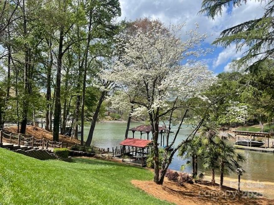 Custom-built 6 BR waterfront home on Lake Norman with covered dock w/boatlift, floating dock, & jetski ramp. This is a great family home but also generated great income as a rental! Enjoy sitting in your WF gazebo or the view from hot tub on extensive decking w/pergola, palm trees, built-in seats & planters and chef's dream outdoor kitchen including brand new Blaze Professional gas grill, pizza oven, stovetop burner, beverage fridge, sink surrounded by granite & stone bar all on covered tile patio! Home has 6 BR, 3 BA but county says 4. Basement includes upgraded full kitchen, rec rm w/pool table, familyrm w/fireplace, & BR w/BA. Main floor greatrm boasts high ceilings, stone fireplace, tons of windows & leads out to screened-in porch overlooking lake. Entire home has been repainted inside and out, NEW roof & gutters, hardwoods refinished, NEW carpet, fixtures, SS appliances, & Generac generator. Other features include greenhouse, garden shed, and chicken coop if buyer desires! No HOA!