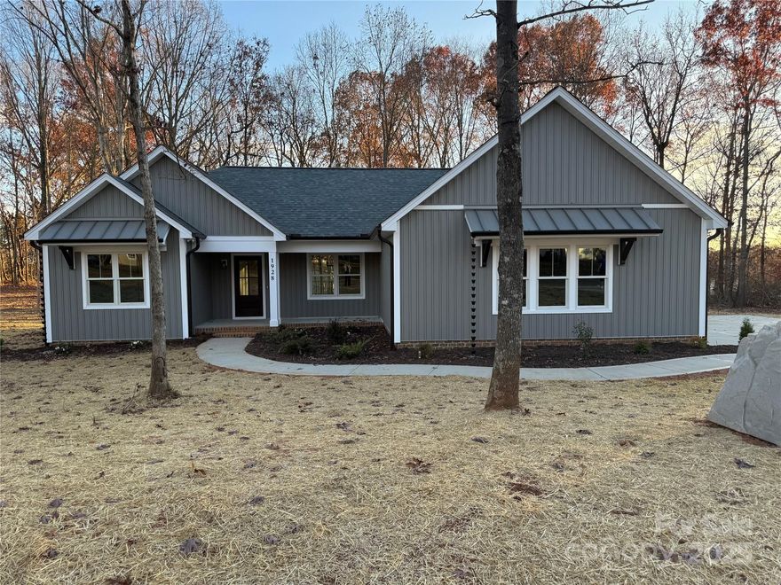Fall in love with this spacious Custom-built new construction ranch home. You are greeted with a welcoming front porch with a beautiful wood 3/4 glass entry door. Added to the curb appeal is metal overhangs that has beautiful cedar corbels for a stunning front elevation. This beautiful home offers an open floor plan with split bedrooms. The spacious kitchen has lots of storage with white shaker cabinets on the perimeter and a stunning wood island, paired with beautiful Quartz countertops and an elegant backsplash. The floors are durable luxury vinyl in the living areas and bedrooms, and gorgeous tile in both bathrooms. The home offers a mud room/drop zone with built-ins upon entry from the garage and the laundry conveniently located beside. The Primary Bedroom has a large closet with custom-built closets. The primary bathroom has double sinks and beautiful tile on the walls of the shower. The living room has vaulted ceilings that enhance the size of the room. The windows are upgraded Andersen windows. You will love spending time on the deck which is constructed with composite decking and aluminum railings for low maintenance living. Beautiful landscaping tops this home off as a must see.