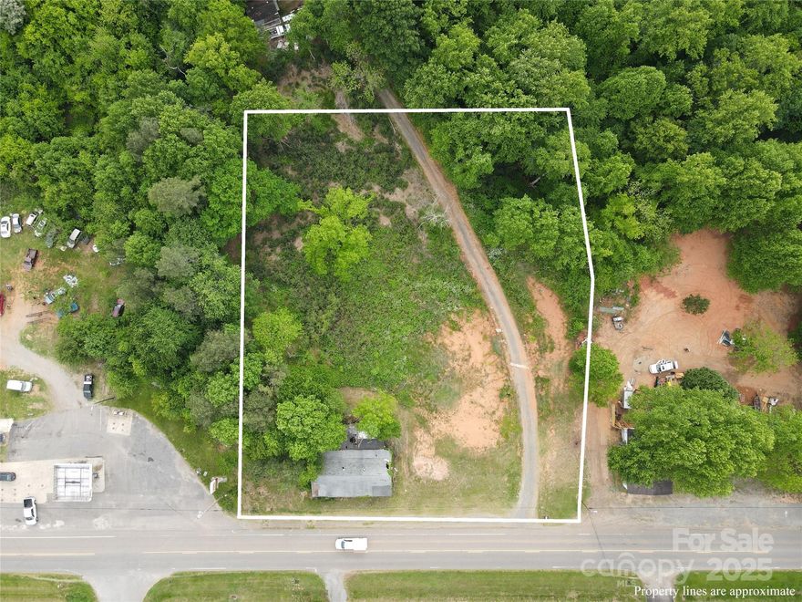 High traffic Highway 115 just north of Statesville. Commercial lot zoned NB with 2030 Horizon Plan being Rural Commercial. A 1.988 acre lot next to a popular gas station located near Trinity Fire Dept. just 5 miles north of Statesville city limits and about a 6 minute drive with folks commuting past the property in both directions north and south. Property is still in the Central School & North Iredell School Districts. Lot is partially cleared and has a slope down toward the back of the lot. There is an old building on the property that would need work.  Septic already installed on property and county water available. Great spot to attract a lot of business!  This stretch of Hwy 115 is a popular route to and from Wilkesboro & North Wilkesboro, folks heading to & from the mountains as well all of the many local residents that travel by the property. Buyer will need to contact Iredell County planning & zoning for questions and approval of business and use.